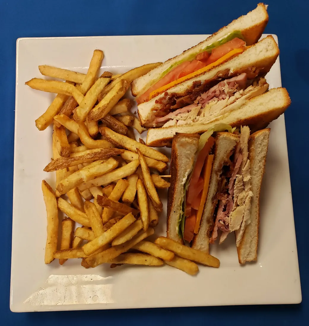 Clubhouse sandwich with turkey, ham and bacon, served with fries at Cheryl's Country Kitchen in Airdrie, AB