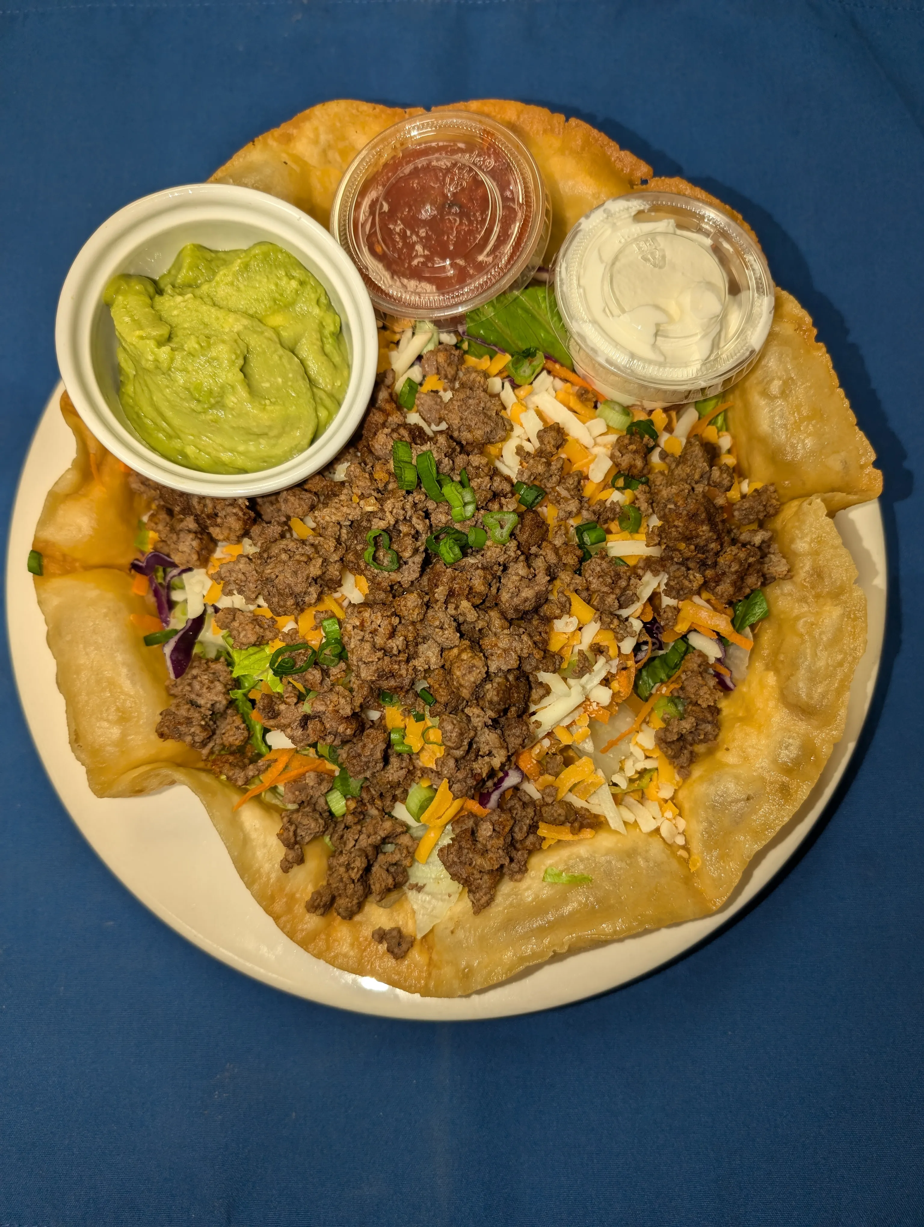 Taco salad in a crisp edible bowl with seasoned beef, cheese, salsa and sour cream at Cheryl's Country Kitchen in Airdrie, AB